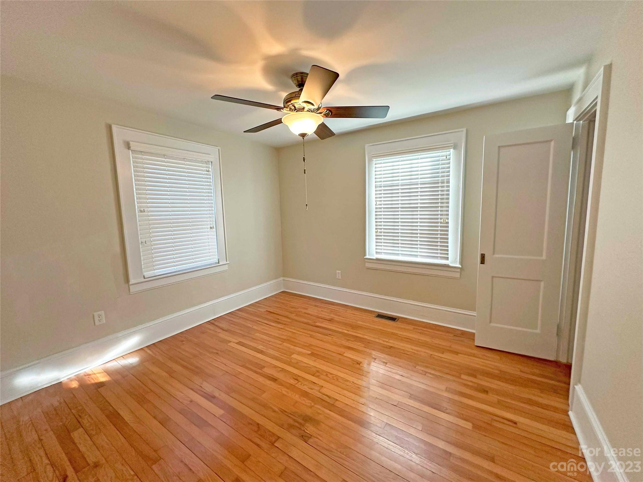 Undisclosed Address Hickory, NC 28601 - Photo 14 of 19 a view of an empty room with wooden floor and a window