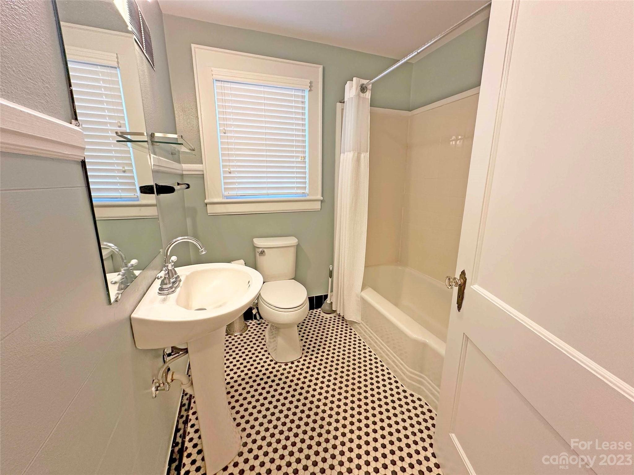 Undisclosed Address Hickory, NC 28601 - Photo 16 of 19 a bathroom with a sink a toilet a mirror and shower