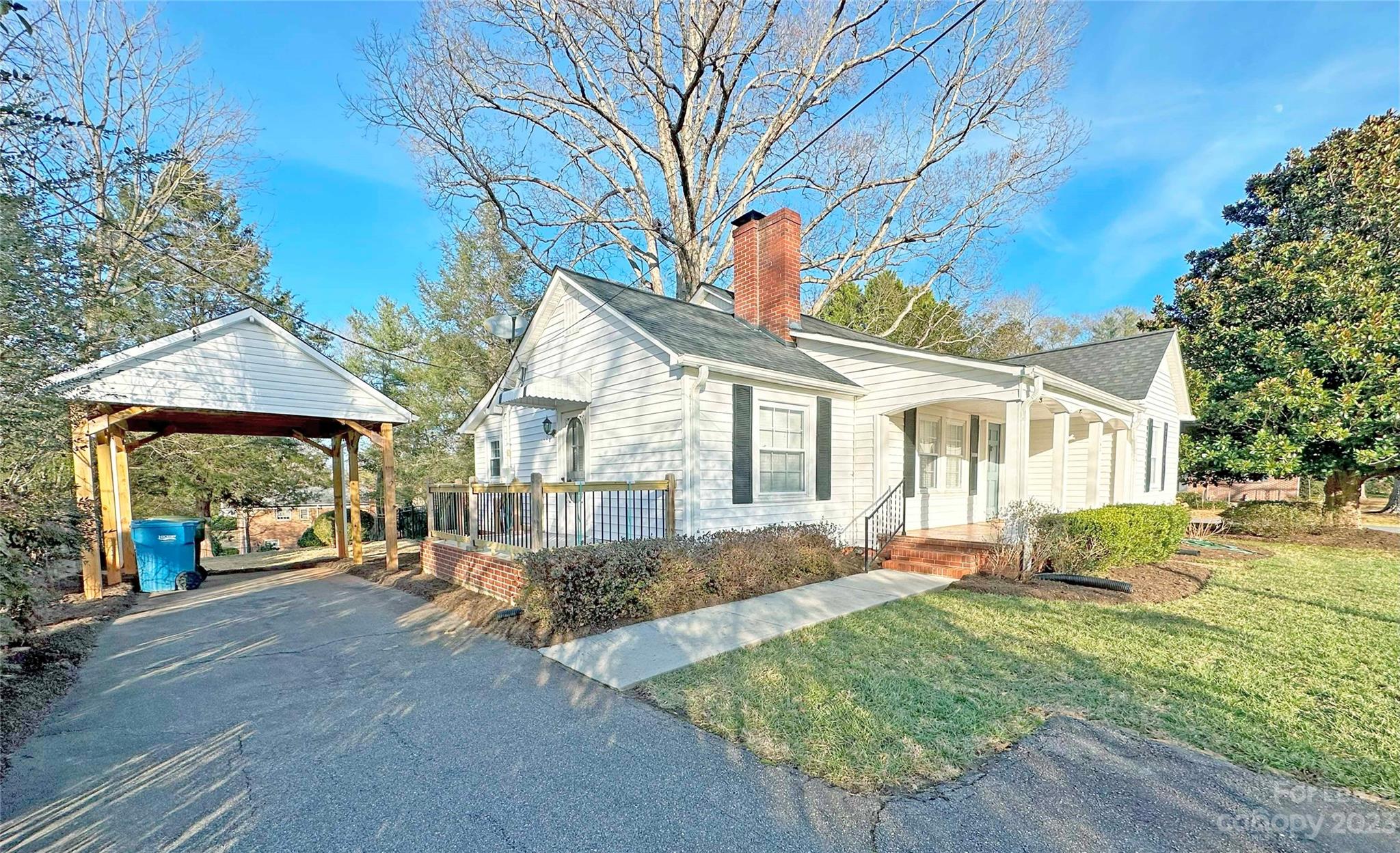 Undisclosed Address Hickory, NC 28601 - Photo 2 of 19 a front view of a house with a yard and potted plants