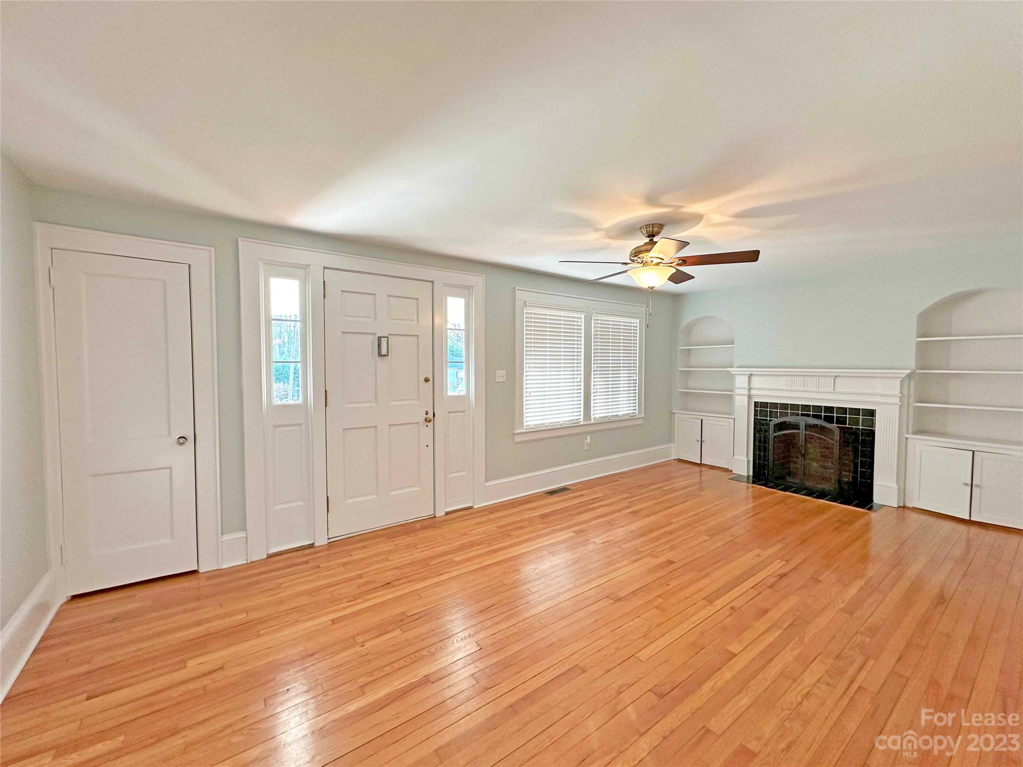 Undisclosed Address Hickory, NC 28601 - Photo 4 of 19 a view of empty room with wooden floor and fireplace