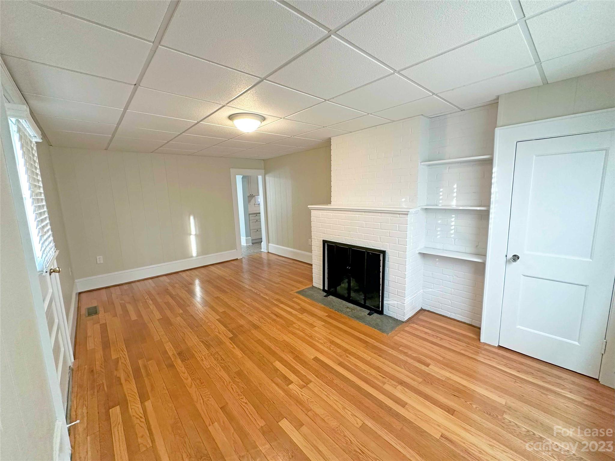 Undisclosed Address Hickory, NC 28601 - Photo 6 of 19 a view of empty room with wooden floor and fireplace