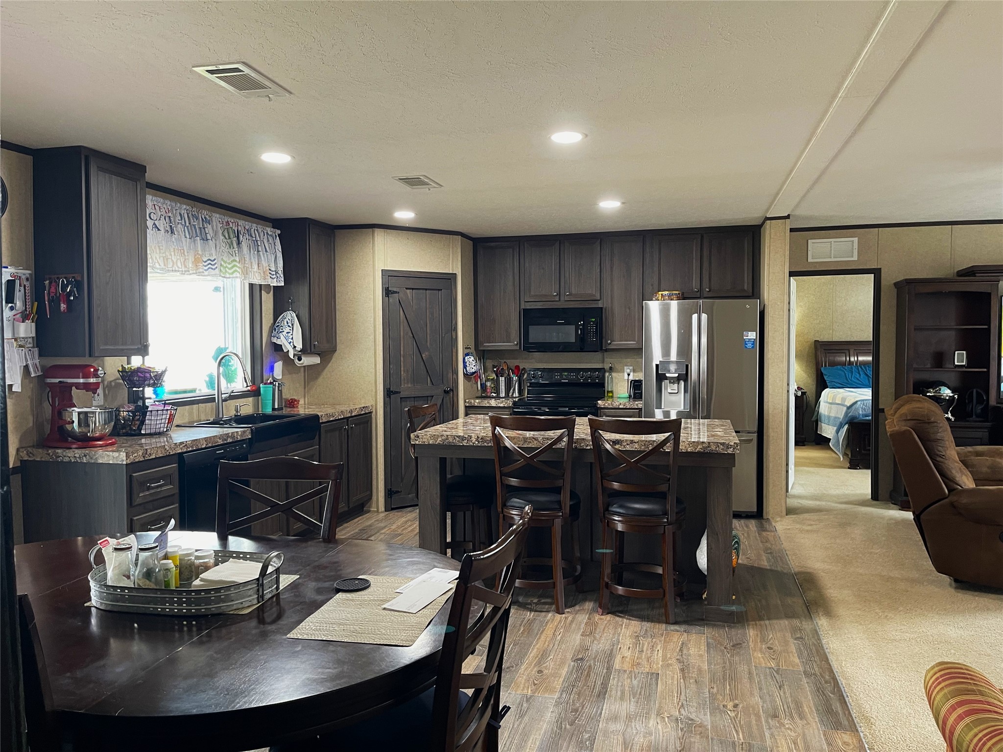 351 Clb Lk Road Teague, TX 75860 - Photo 13 of 33 a kitchen with kitchen island granite countertop a sink counter top space and stainless steel appliances