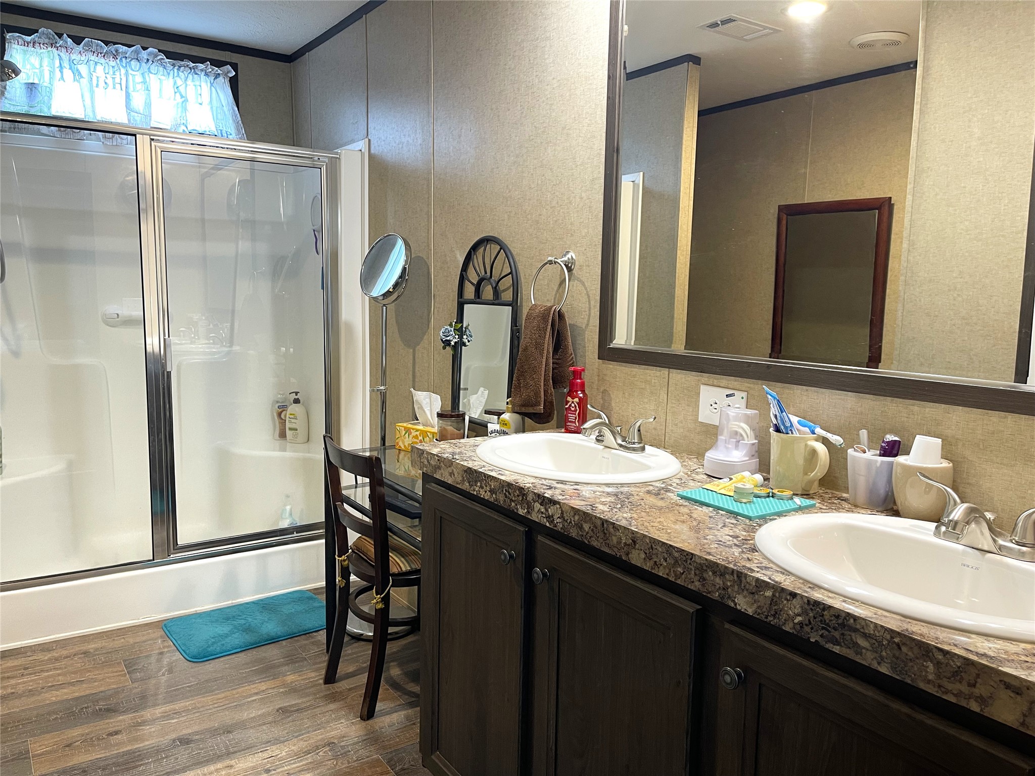 351 Clb Lk Road Teague, TX 75860 - Photo 15 of 33 a bathroom with a granite countertop sink a mirror and a shower