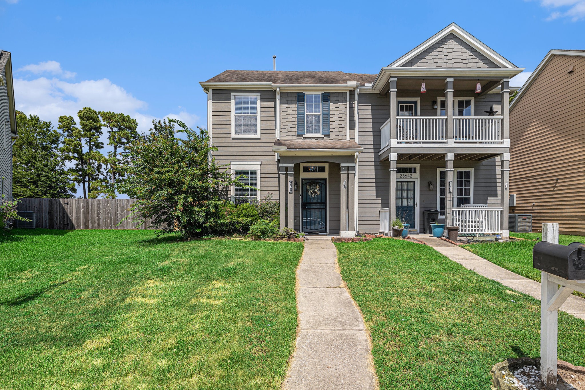a front view of a house with a yard and porch