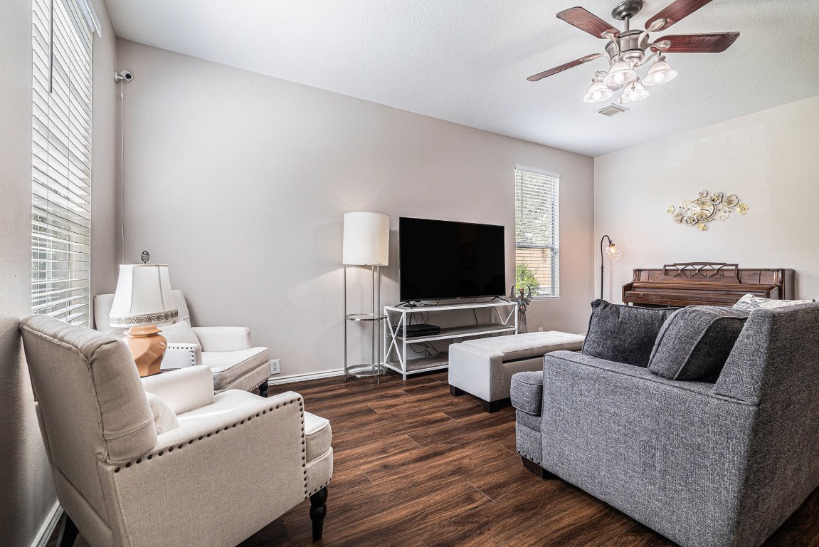 Bright, open living room with new LVP flooring, abundant natural light and a seamless flow into the kitchen and dining areas.