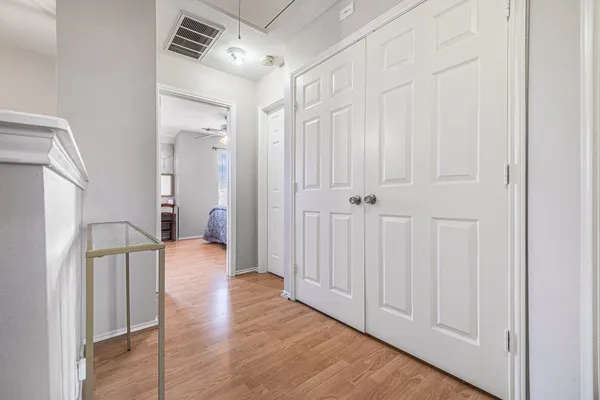 a view of a hallway with wooden floor