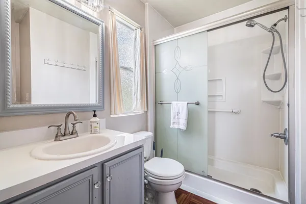 a bathroom with a sink toilet and shower