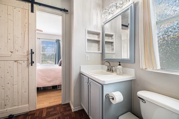 a en suite bathroom with a sink and a mirror