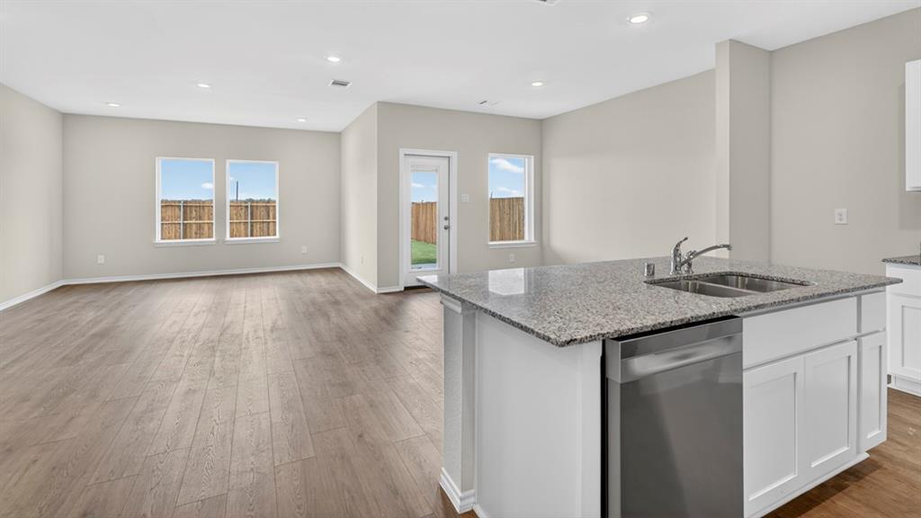4008 Ripplewood Drive Lindale, TX 75771 - Photo 33 of 37 Open-concept living space featuring wood-finish flooring, recessed lighting, and light gray walls