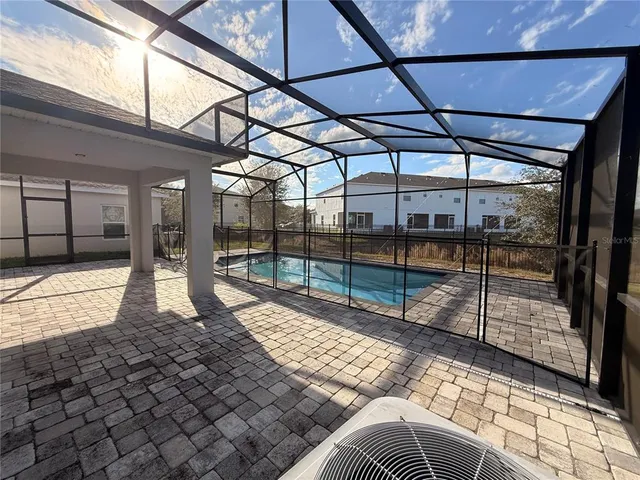 a view of a porch with a table and chairs
