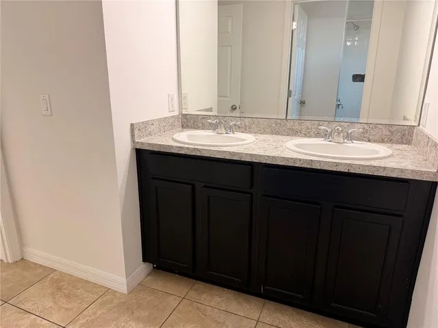 a bathroom with a granite countertop sink and vanity