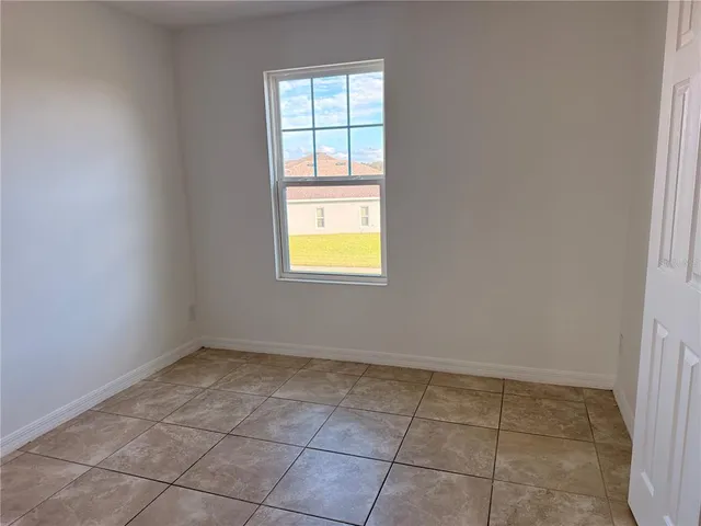 a view of a room with a ceiling fan and a window