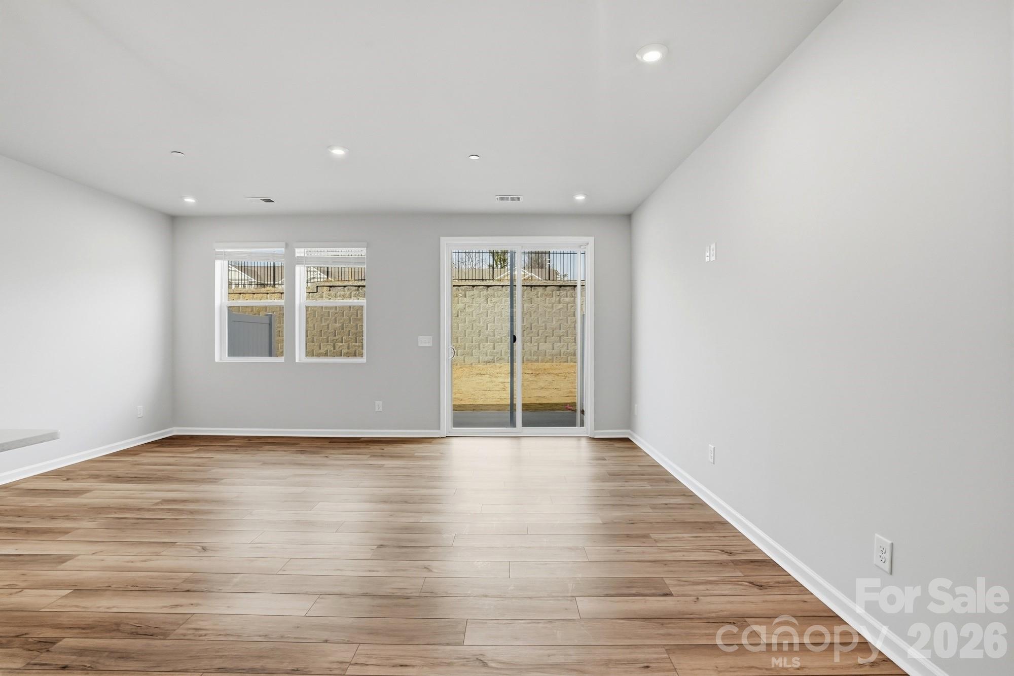 2540 Hedgecliff Road Kannapolis, NC 28083 - Photo 9 of 22 a view of an empty room with wooden floor and a window