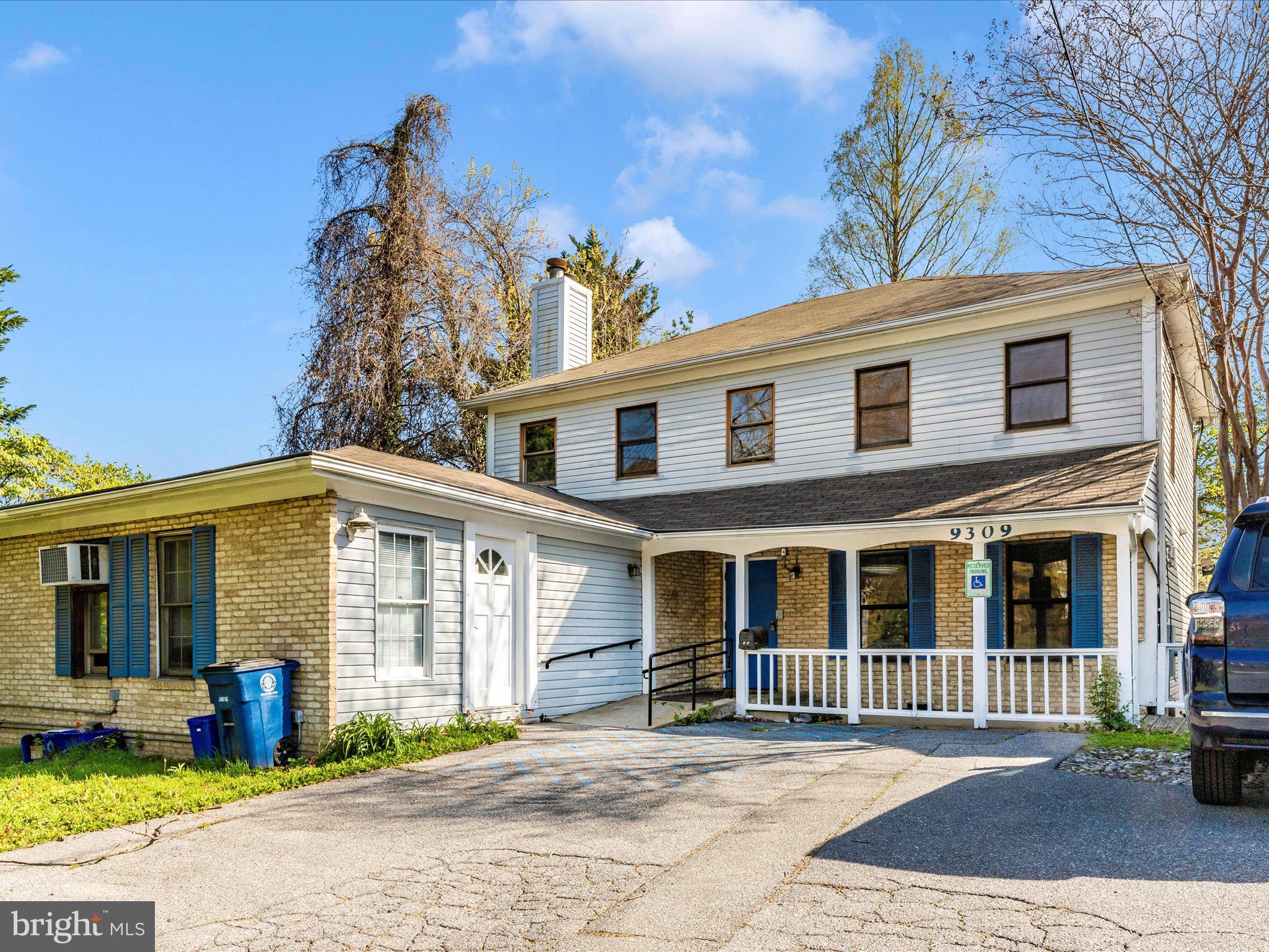 9309 Old Georgetown Road Bethesda, MD 20814 - Photo 1 of 50 a front view of a house with a garden and patio