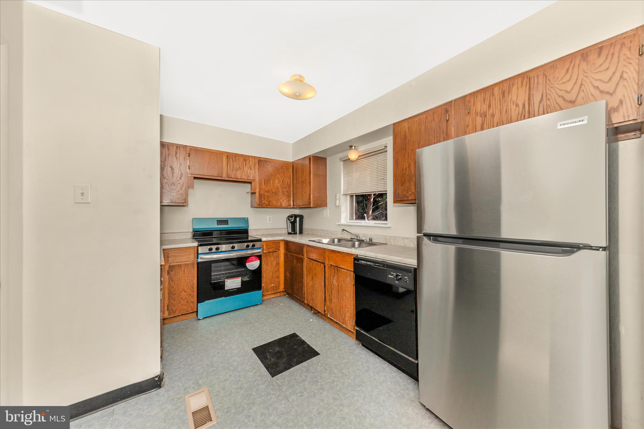 9309 Old Georgetown Road Bethesda, MD 20814 - Photo 12 of 50 a kitchen with stainless steel appliances a refrigerator sink stove and oven