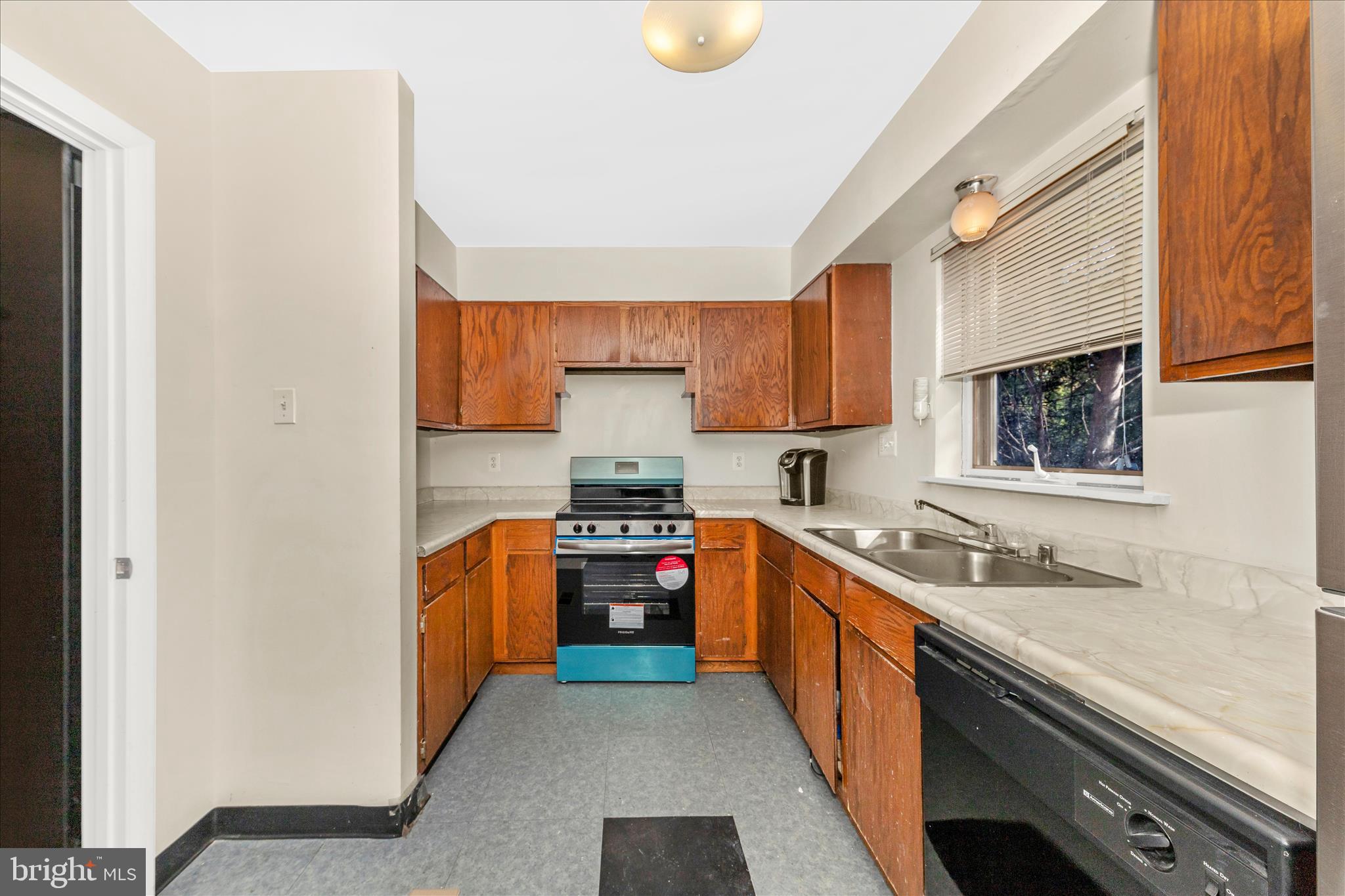 9309 Old Georgetown Road Bethesda, MD 20814 - Photo 13 of 50 a kitchen with stainless steel appliances granite countertop a sink stove and refrigerator