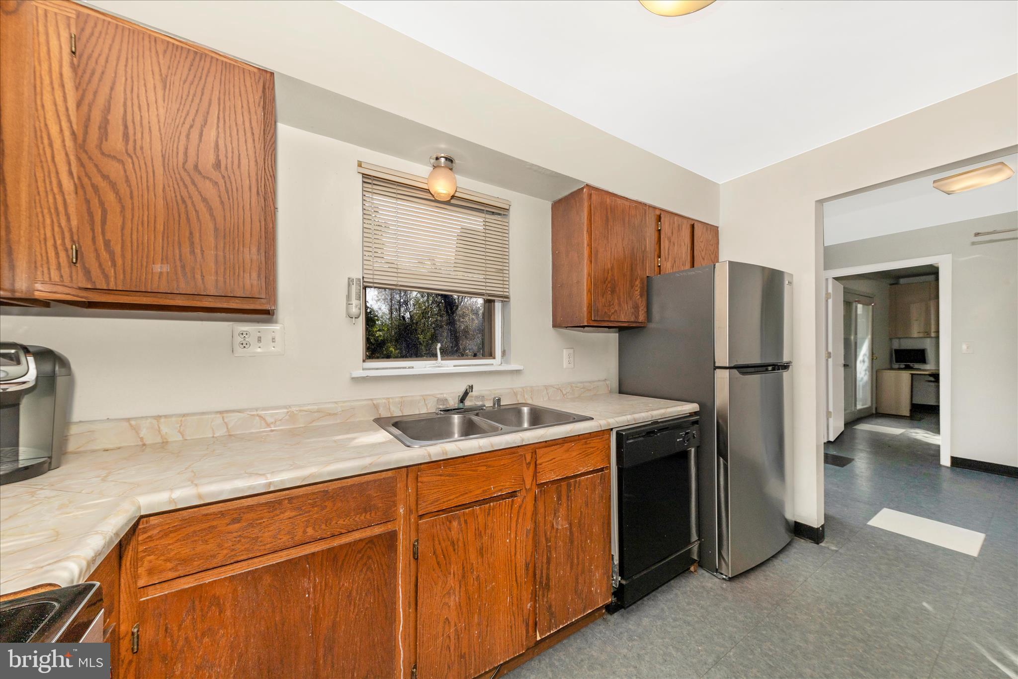 9309 Old Georgetown Road Bethesda, MD 20814 - Photo 14 of 50 a kitchen with stainless steel appliances granite countertop a sink stove and refrigerator