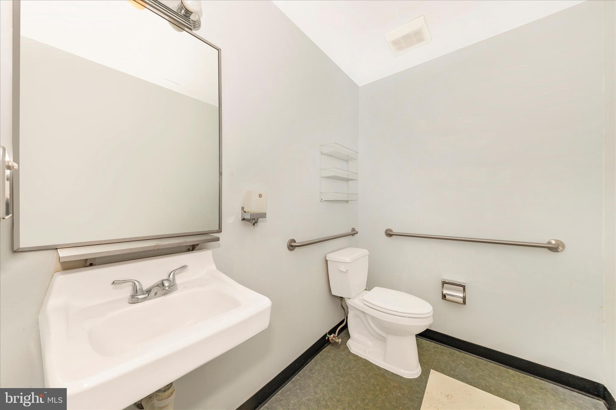 9309 Old Georgetown Road Bethesda, MD 20814 - Photo 15 of 50 a bathroom with a sink a toilet and a mirror