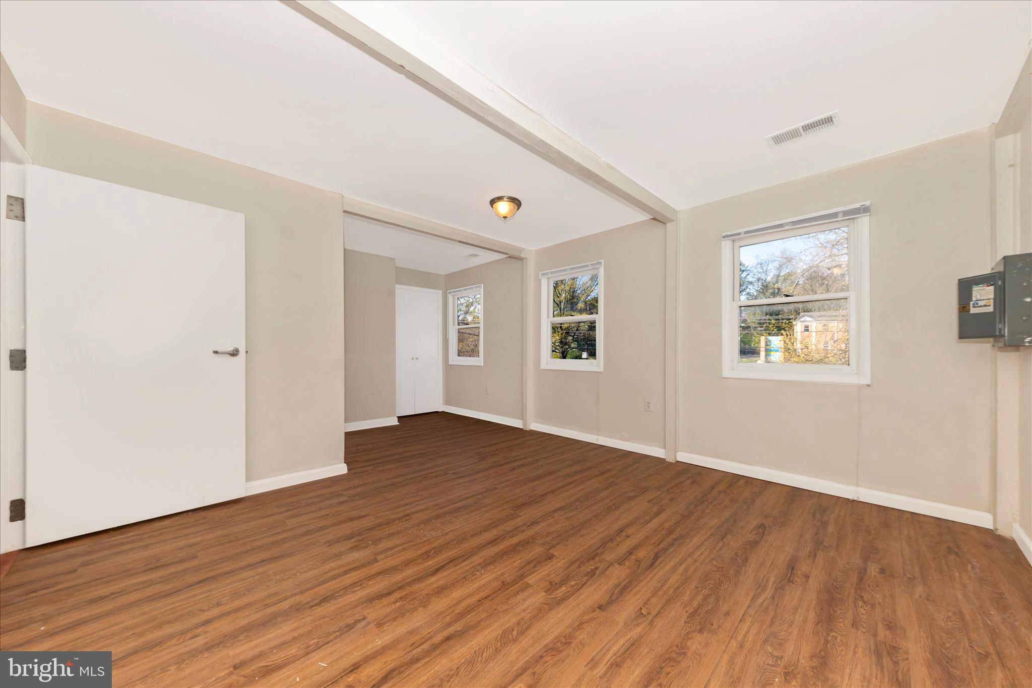 9309 Old Georgetown Road Bethesda, MD 20814 - Photo 18 of 50 a view of an empty room with wooden floor and a window