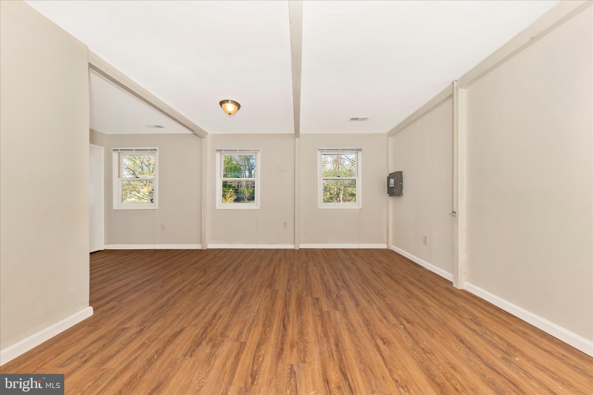 9309 Old Georgetown Road Bethesda, MD 20814 - Photo 19 of 50 an empty room with wooden floor windows and ceiling fan