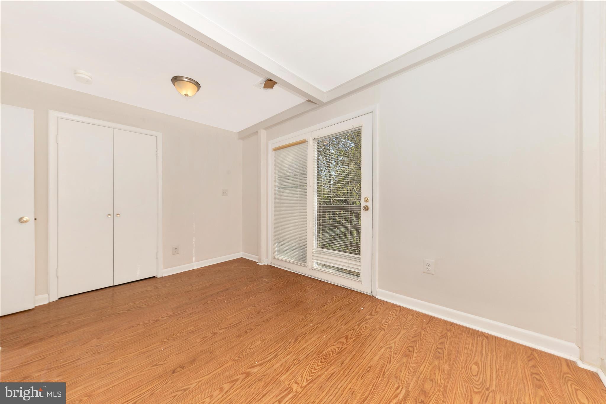 9309 Old Georgetown Road Bethesda, MD 20814 - Photo 25 of 50 an empty room with wooden floor and windows