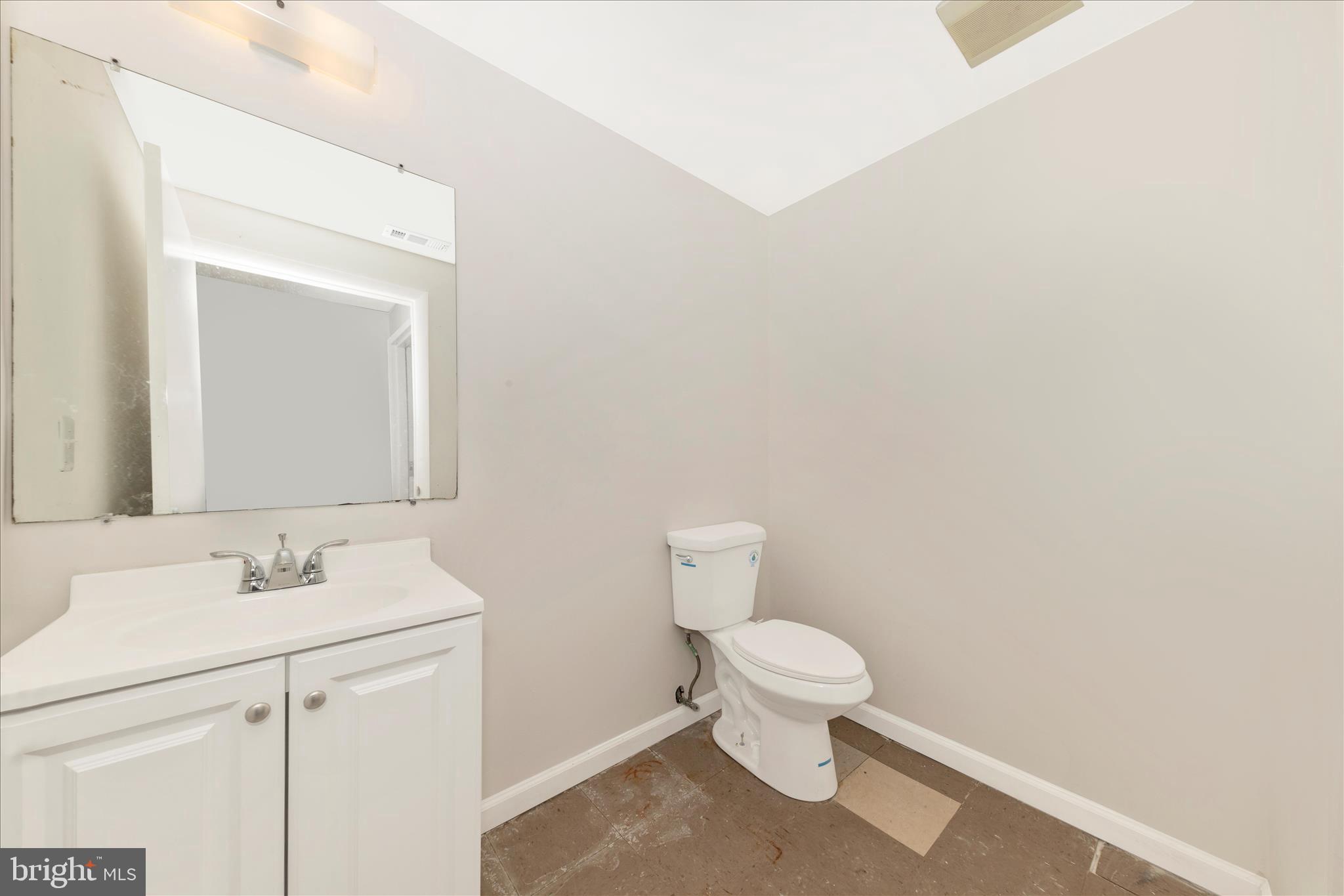 9309 Old Georgetown Road Bethesda, MD 20814 - Photo 32 of 50 a bathroom with a toilet sink and mirror