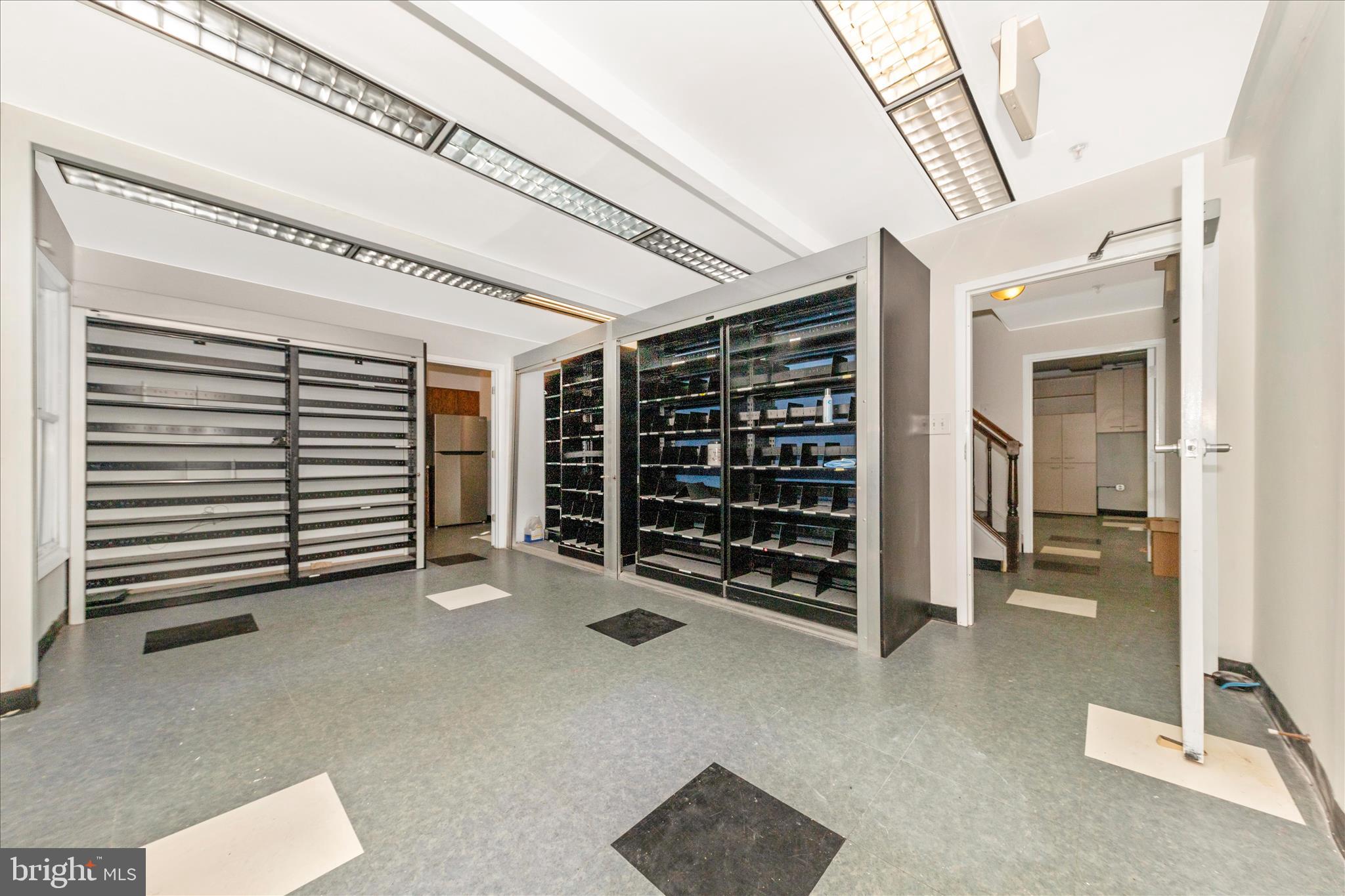 9309 Old Georgetown Road Bethesda, MD 20814 - Photo 9 of 50 a view of an empty room with a fireplace and cabinets