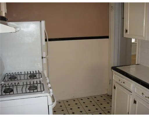 a kitchen with a refrigerator and a stove