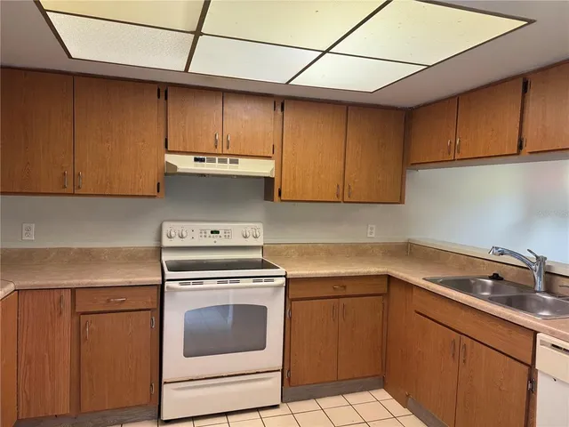 a kitchen with a sink cabinets and appliances