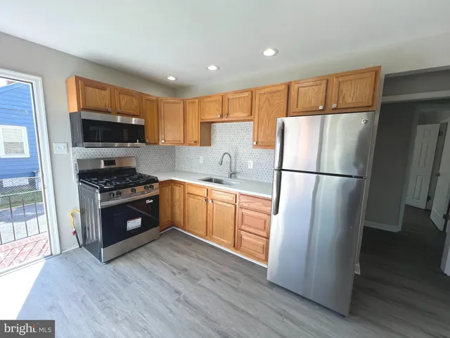 a kitchen with stainless steel appliances a refrigerator and a sink