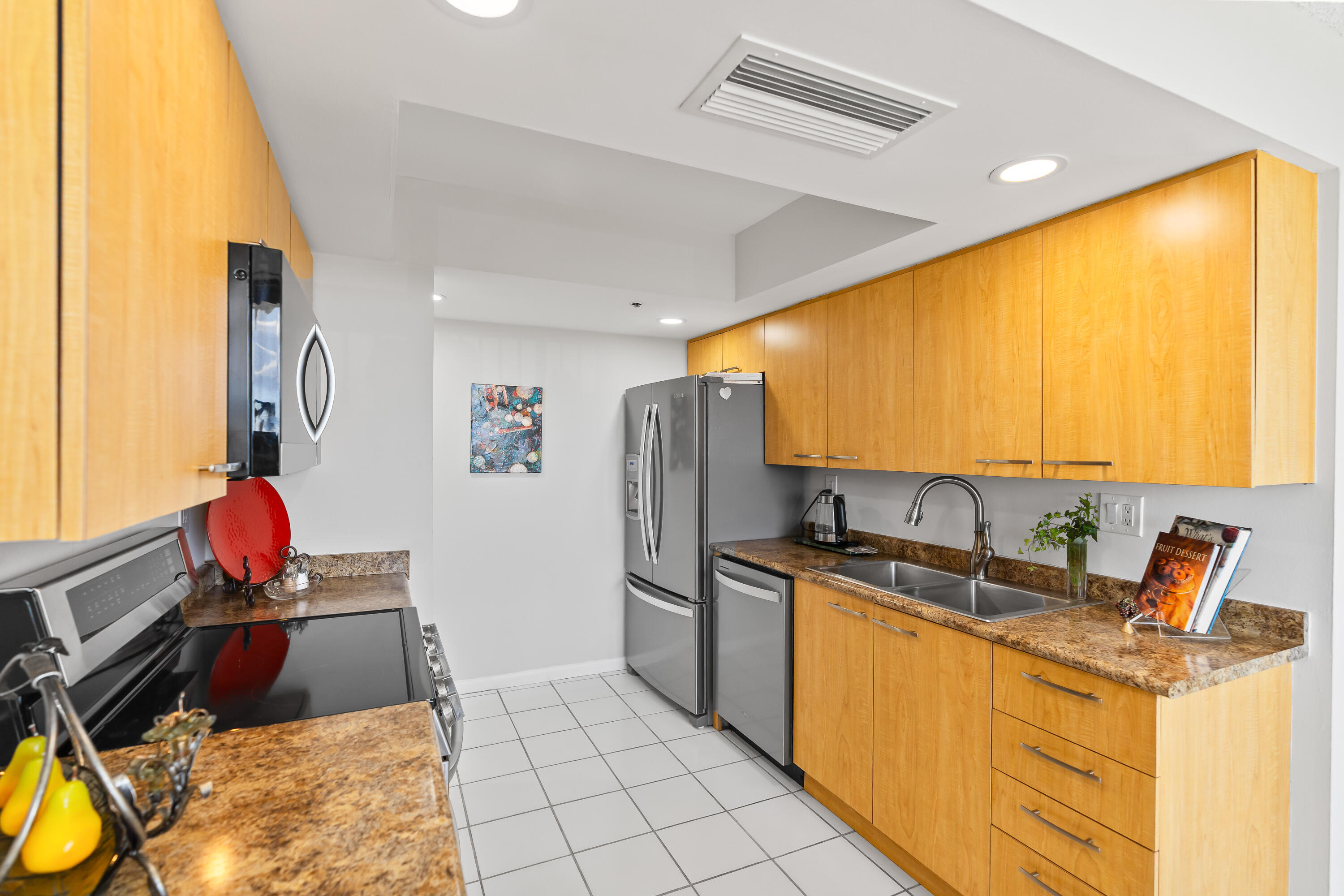 23200 Camino Del Mar, Unit 603 Boca Raton, FL 33433 - Photo 11 of 43 a kitchen that has a sink and a stove top oven