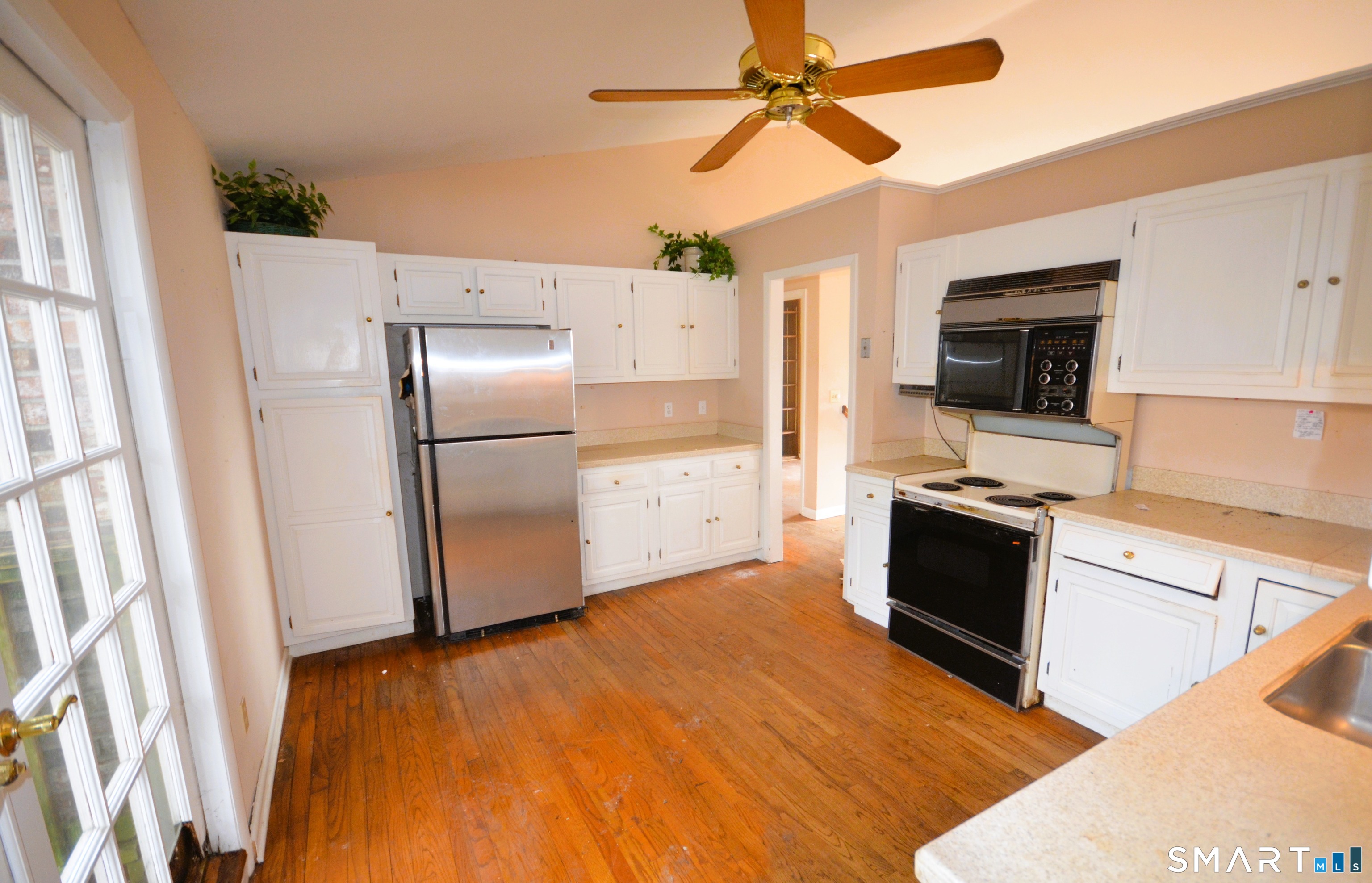 215 Saxonwood Road Fairfield, CT 06825 - Photo 11 of 24 a kitchen with granite countertop a refrigerator a stove top oven a sink and dishwasher