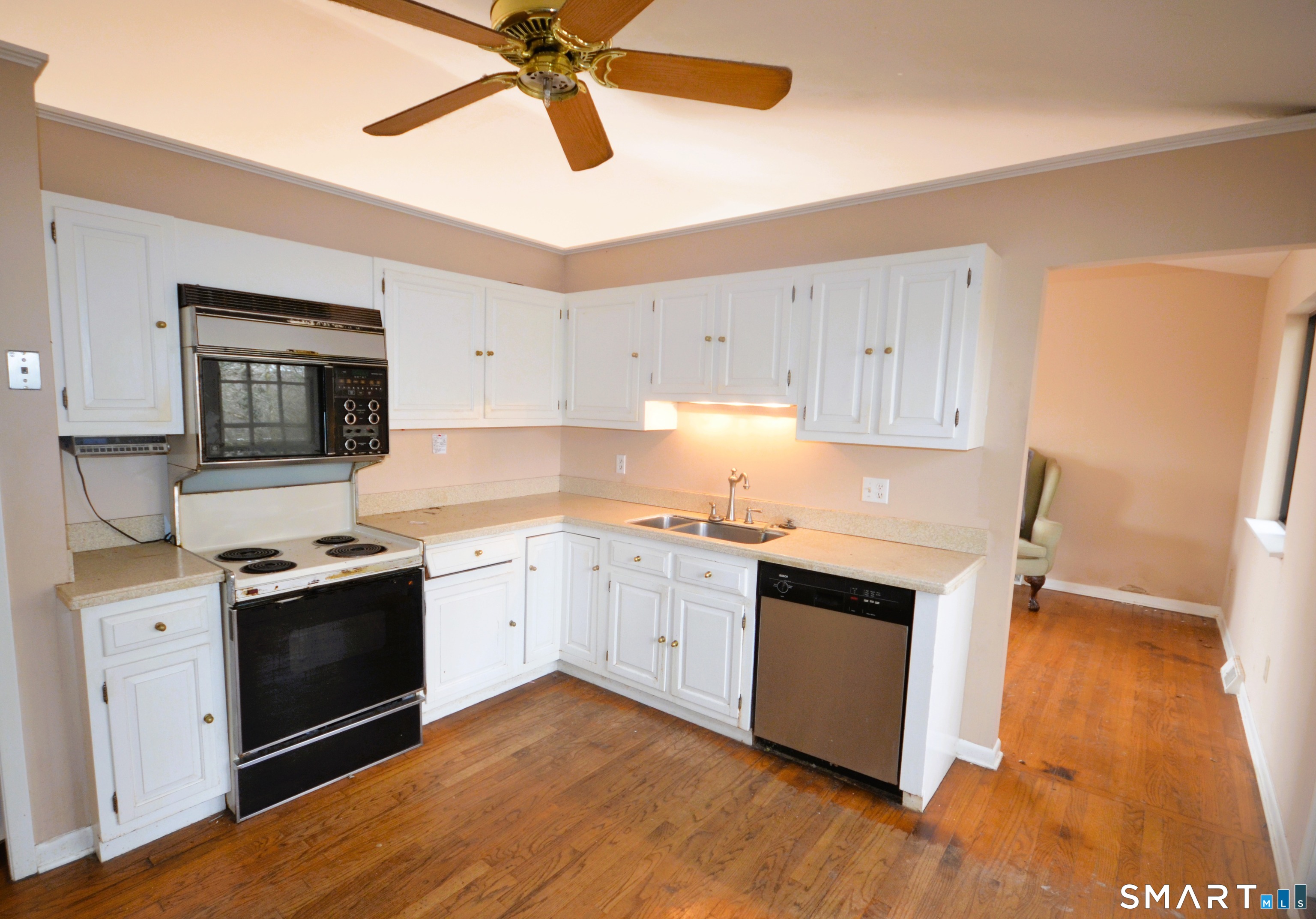 215 Saxonwood Road Fairfield, CT 06825 - Photo 12 of 24 a kitchen with granite countertop white cabinets and white appliances
