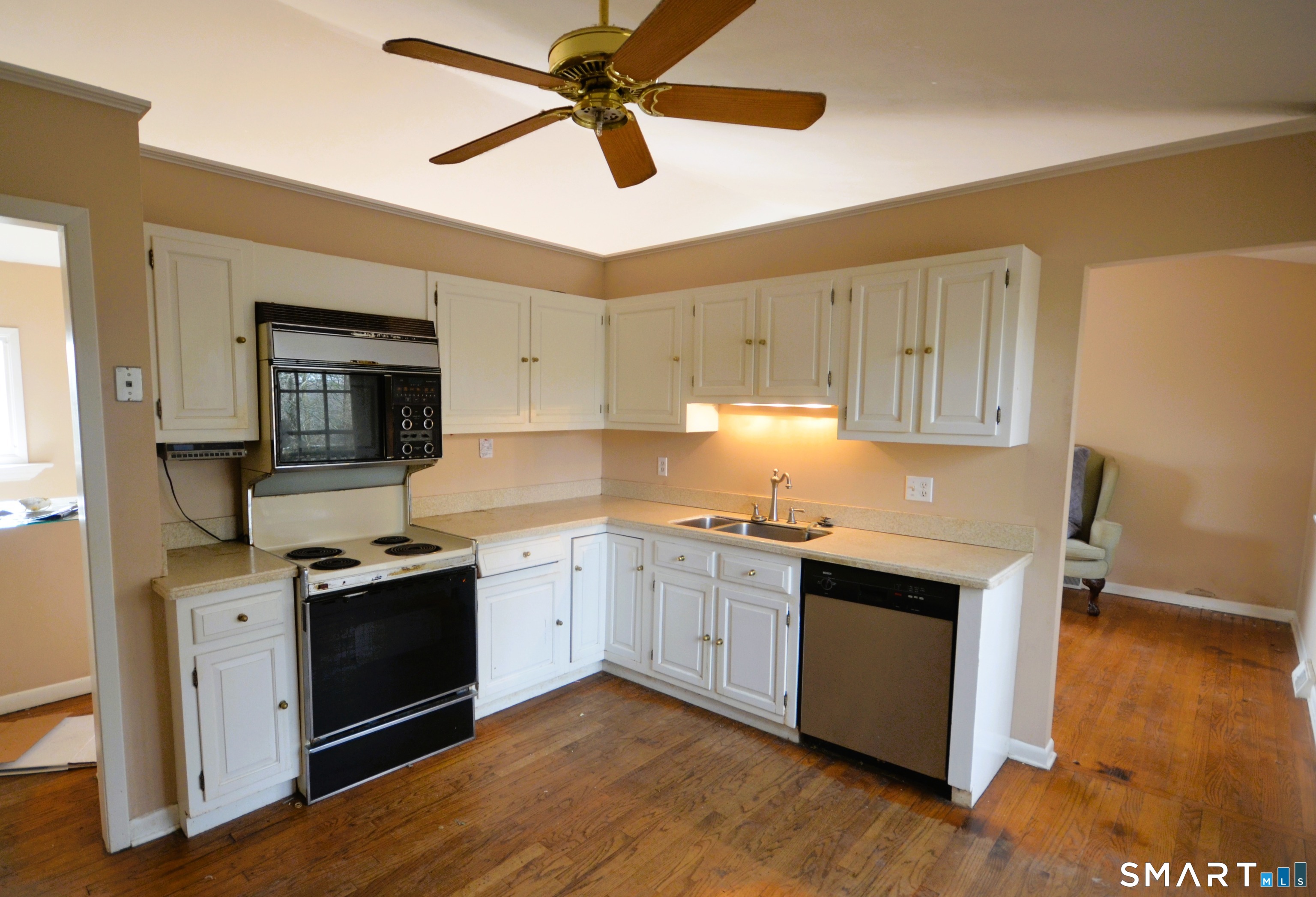 215 Saxonwood Road Fairfield, CT 06825 - Photo 14 of 24 a kitchen with stainless steel appliances granite countertop a sink stove and microwave