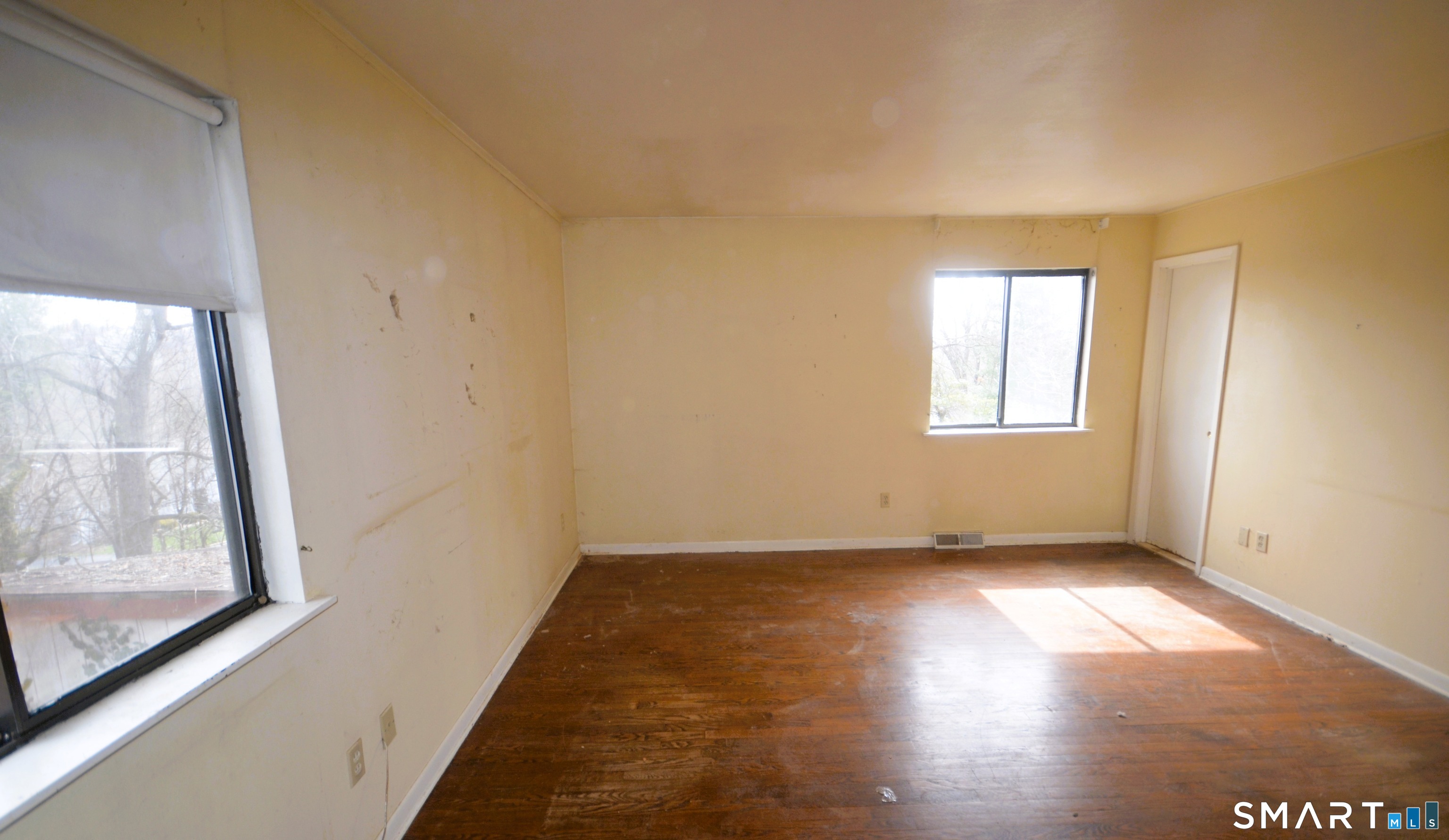 215 Saxonwood Road Fairfield, CT 06825 - Photo 15 of 24 an empty room with wooden floor and windows