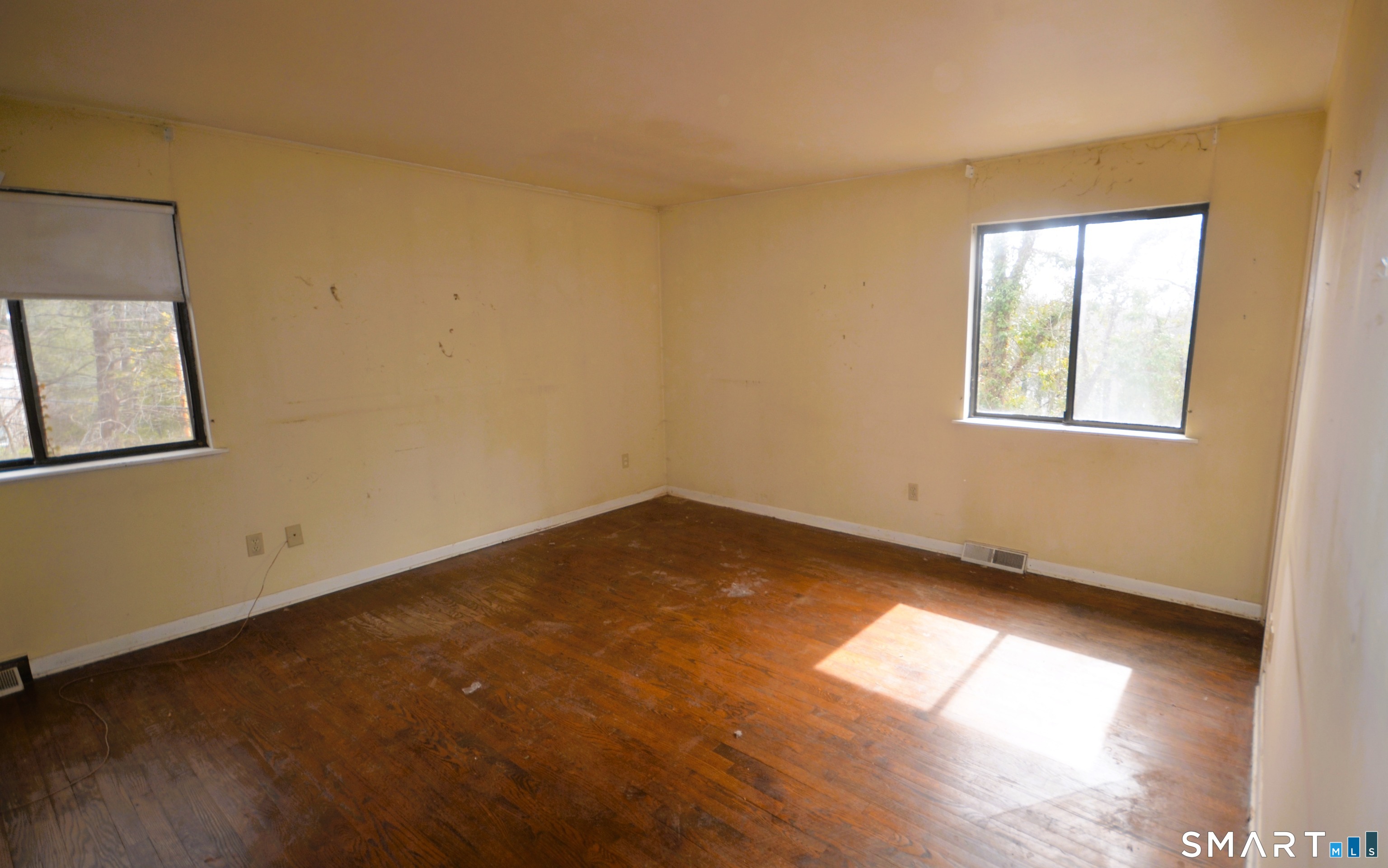 215 Saxonwood Road Fairfield, CT 06825 - Photo 16 of 24 a view of empty room with wooden floor and fan