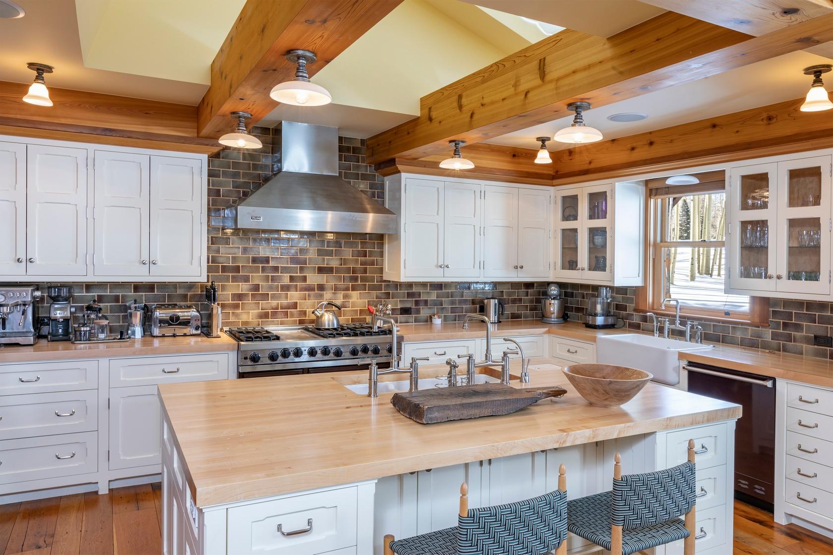 225 Raspberry Patch Road Telluride, CO 81435 - Photo 7 of 24 a kitchen with a stove and a white cabinets