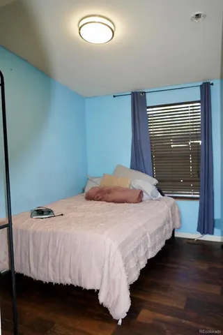 a bedroom with a bed and a mirror