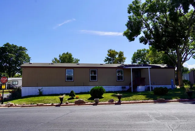 a front view of house with a garden