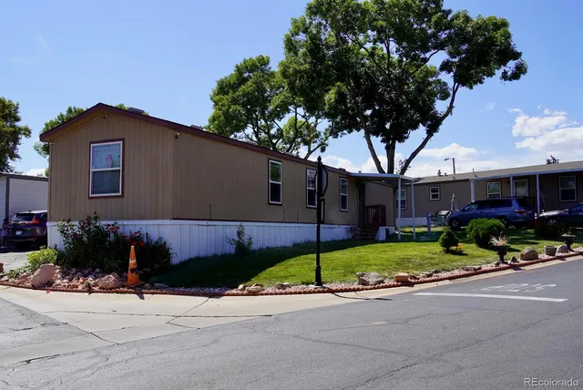 a front view of a house with a yard and a garage