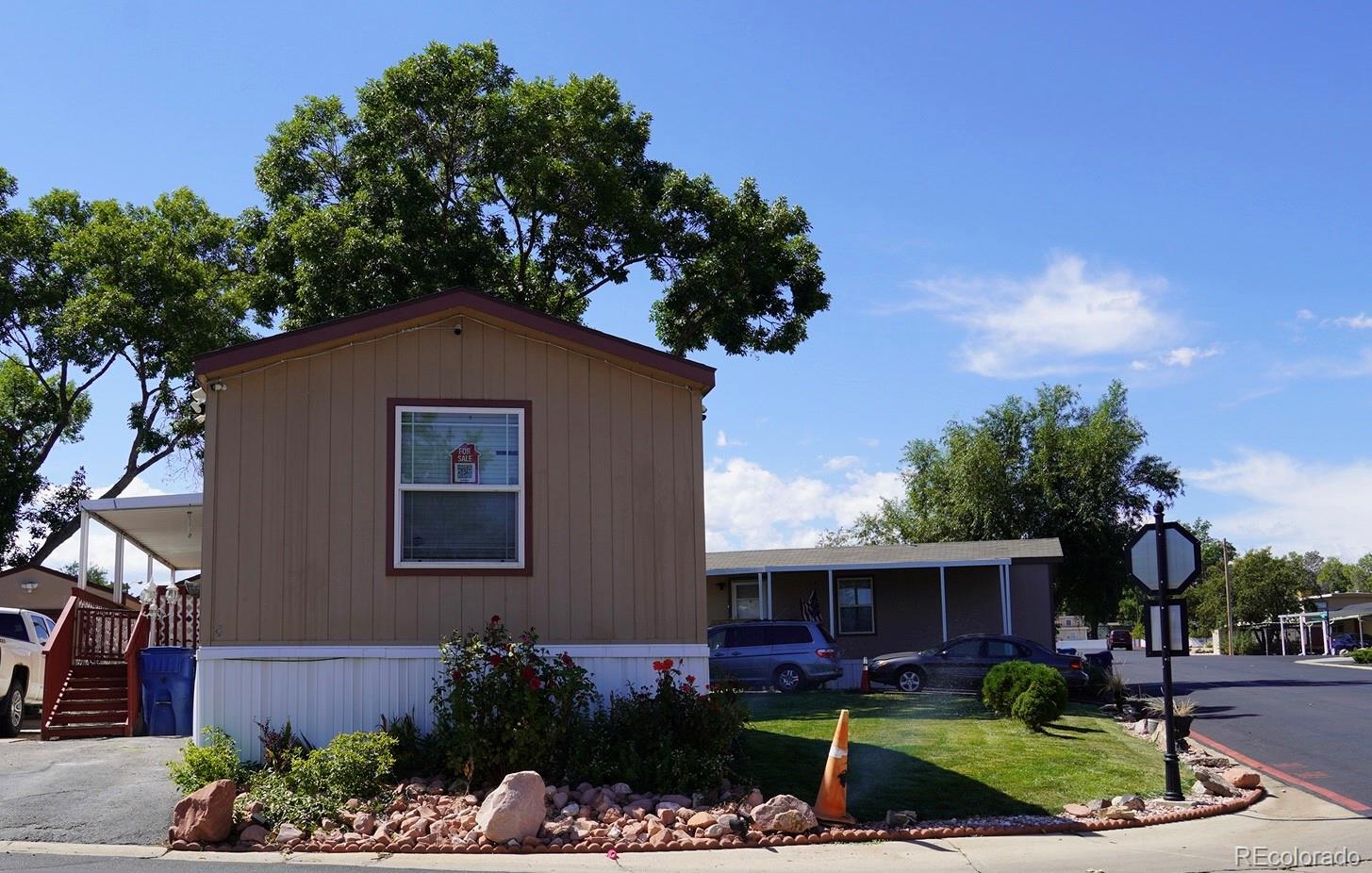 9100 Tejon Street Denver, CO 80260 - Photo 5 of 23 a front view of a house with a yard
