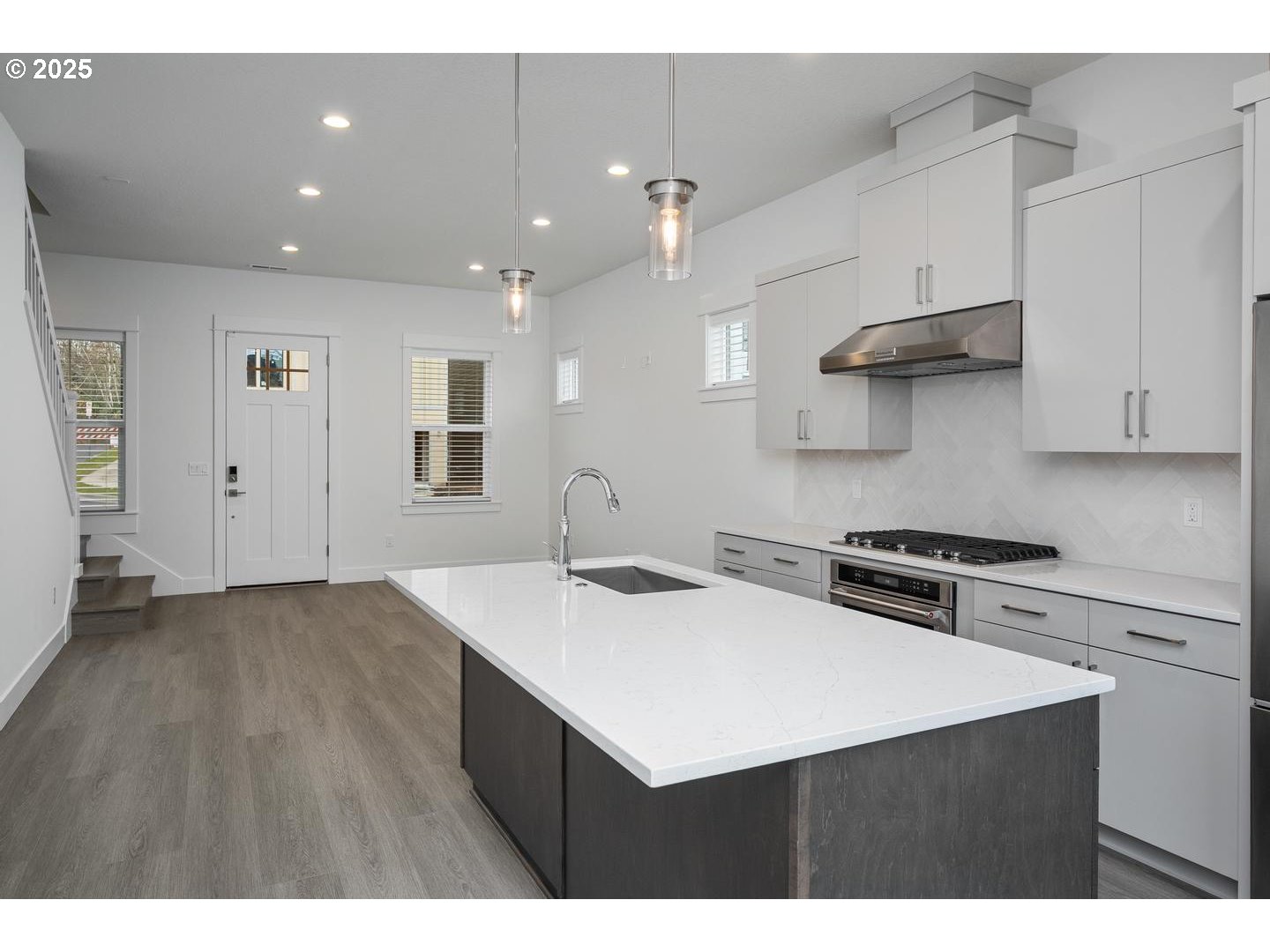 16005 Northwest Holman Way Portland, OR 97229 - Photo 12 of 48 a kitchen that has a sink a stove and cabinets