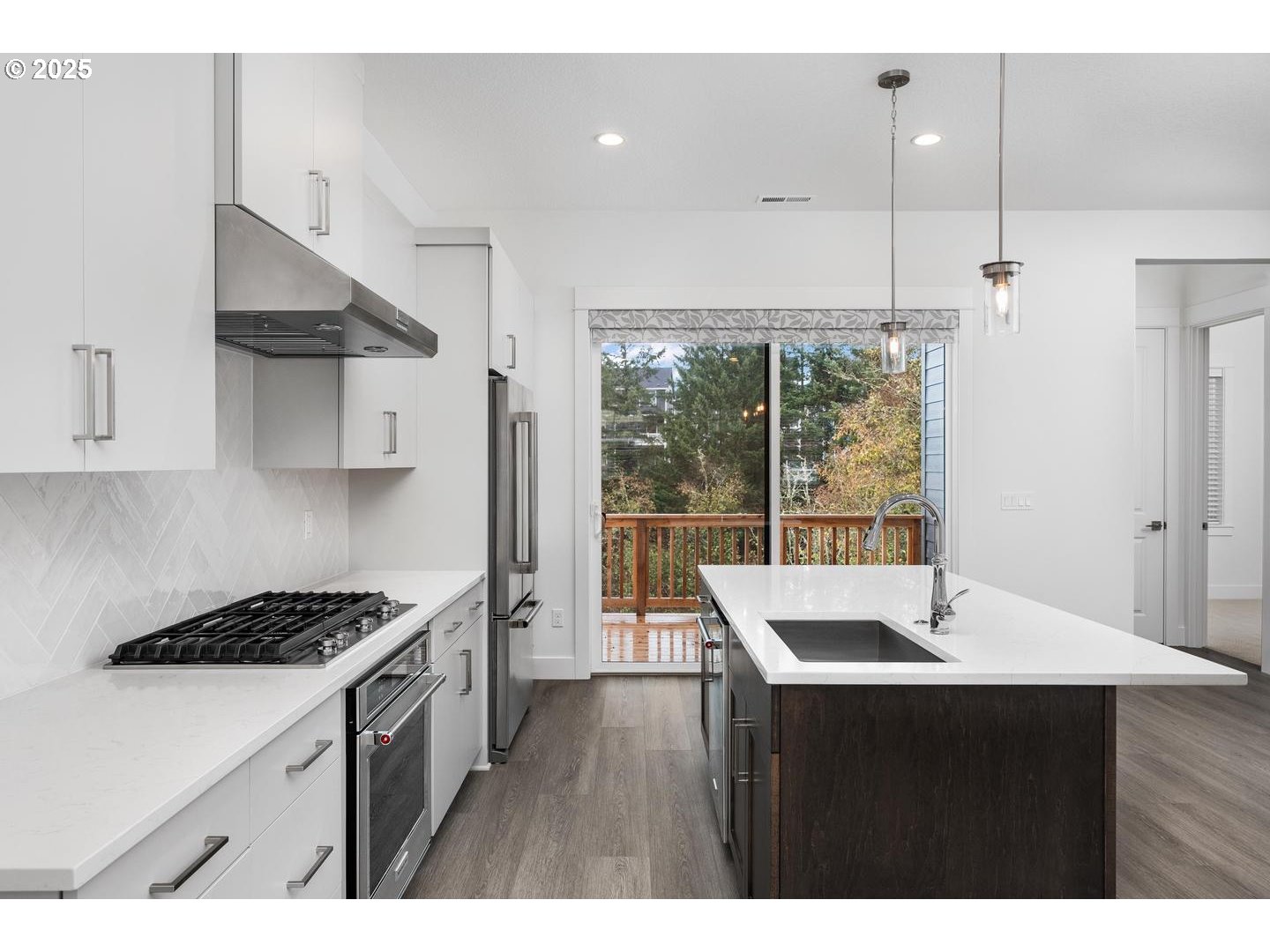 16005 Northwest Holman Way Portland, OR 97229 - Photo 13 of 48 a kitchen with stainless steel appliances a sink a stove and a wooden floor