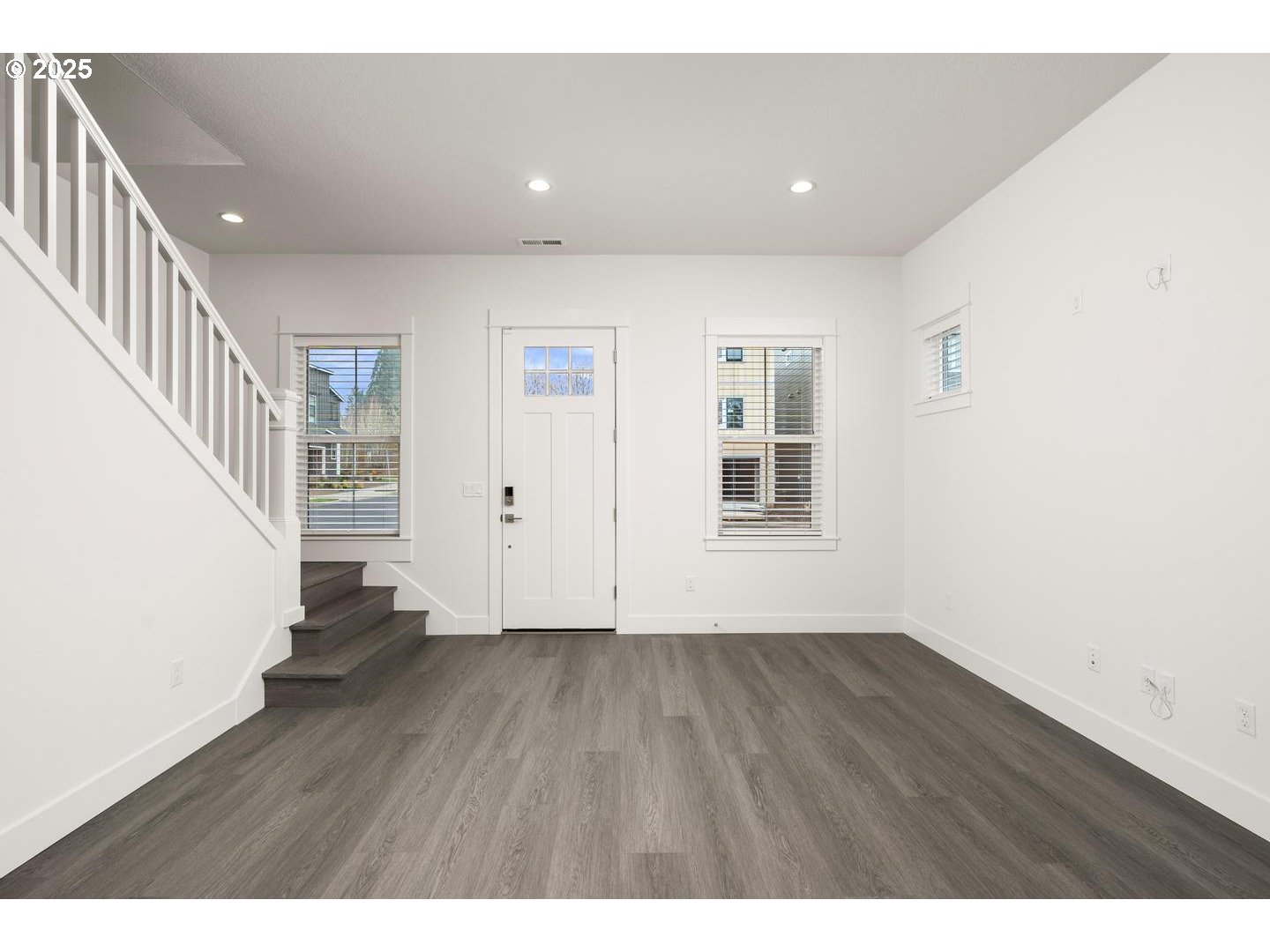 16005 Northwest Holman Way Portland, OR 97229 - Photo 4 of 48 a view of an empty room with wooden floor and stairs