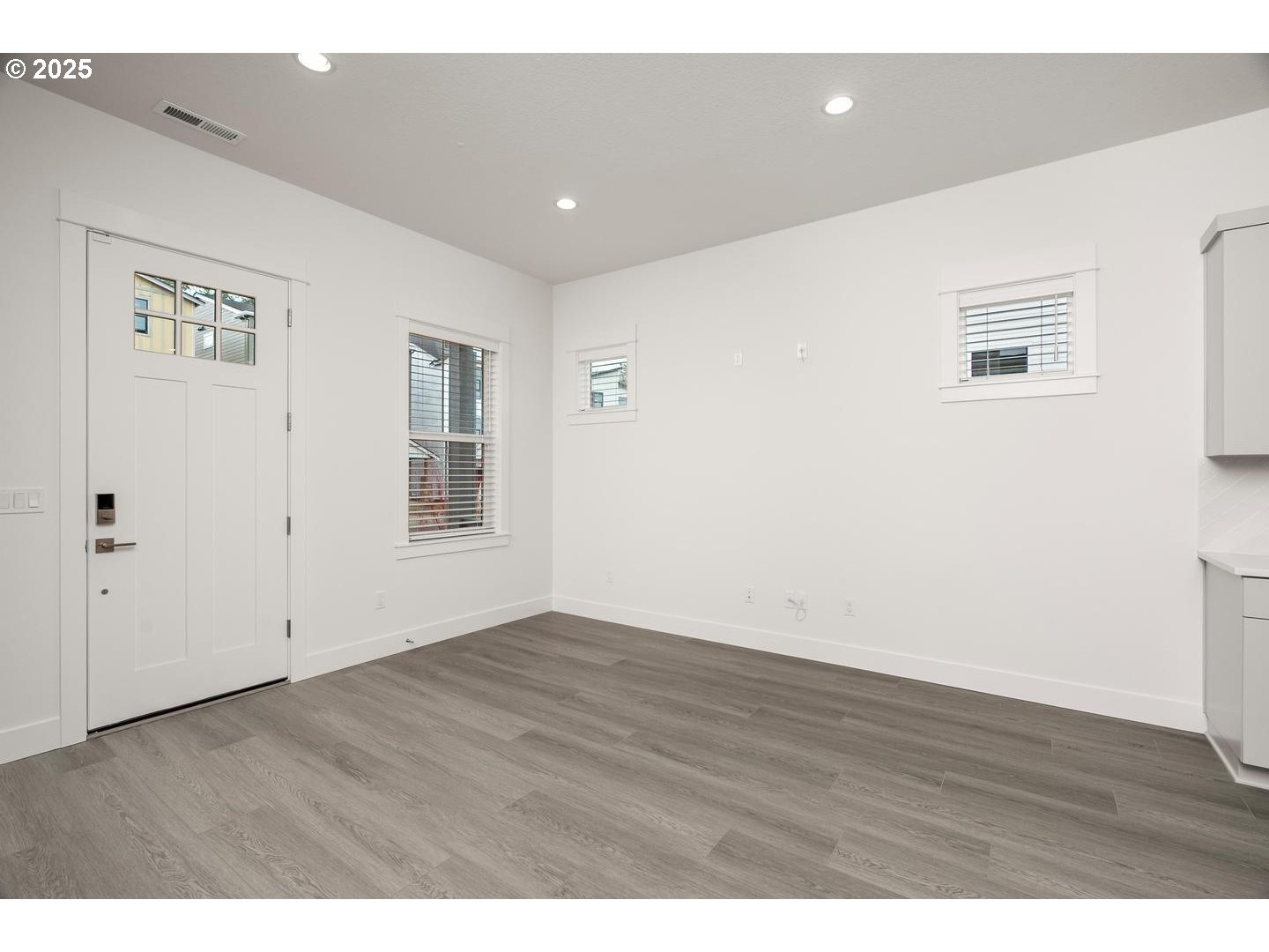 16005 Northwest Holman Way Portland, OR 97229 - Photo 5 of 48 an empty room with wooden floor and windows