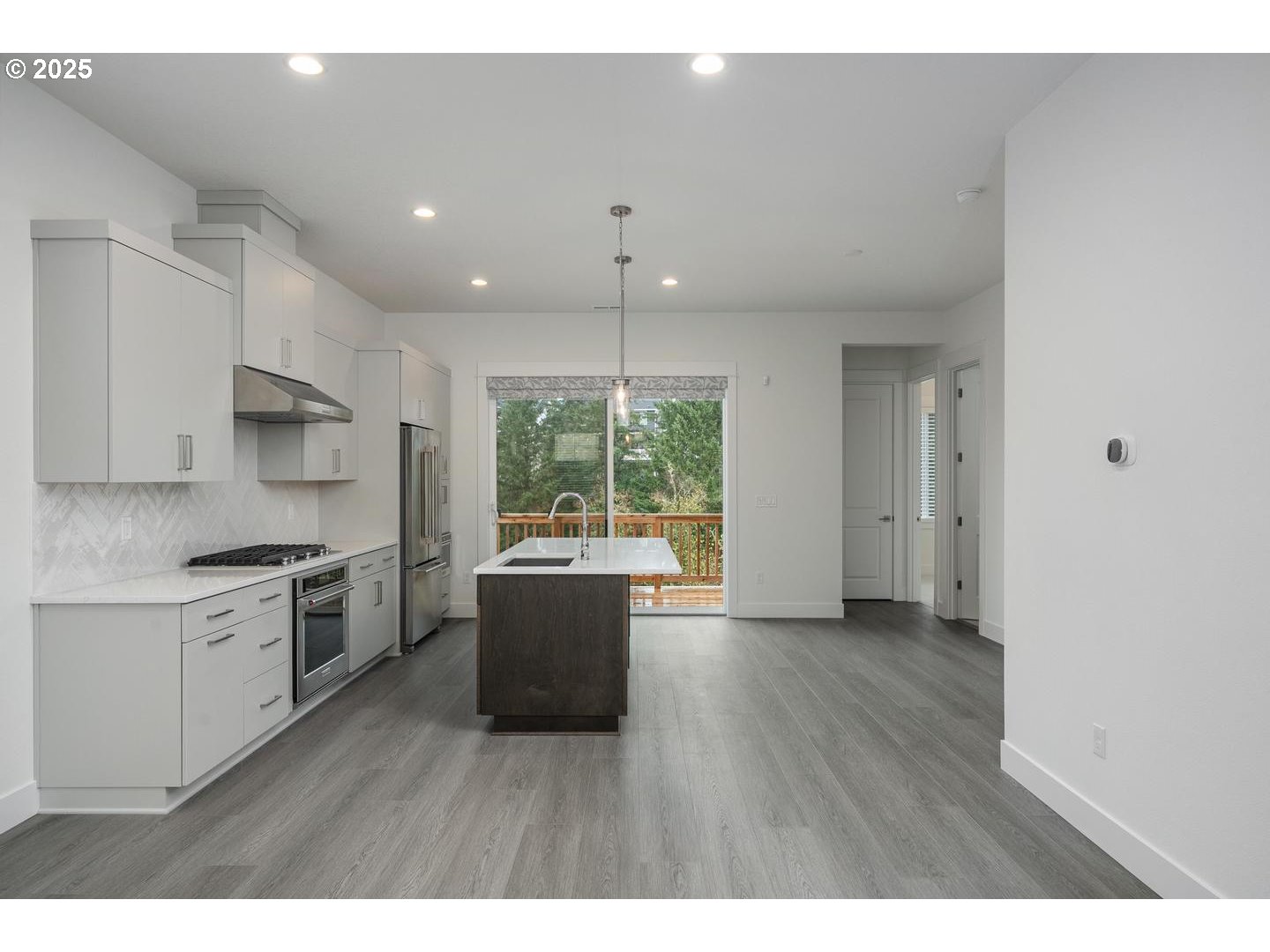 16005 Northwest Holman Way Portland, OR 97229 - Photo 7 of 48 a kitchen with stainless steel appliances granite countertop a stove a sink and a refrigerator