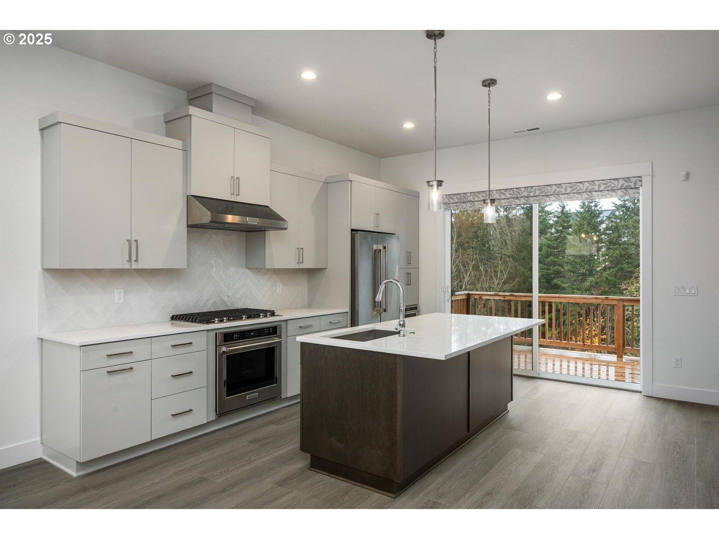 16005 Northwest Holman Way Portland, OR 97229 - Photo 8 of 48 a kitchen with kitchen island a sink stainless steel appliances and cabinets