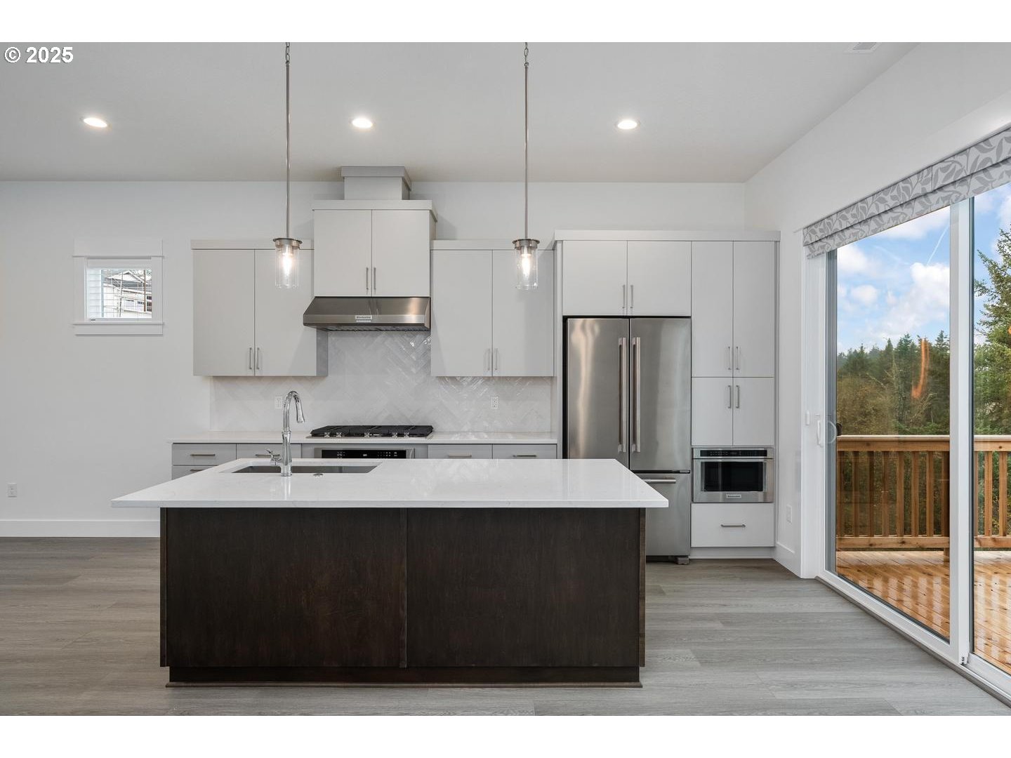 16005 Northwest Holman Way Portland, OR 97229 - Photo 10 of 48 a kitchen with a stove a refrigerator and wooden cabinets