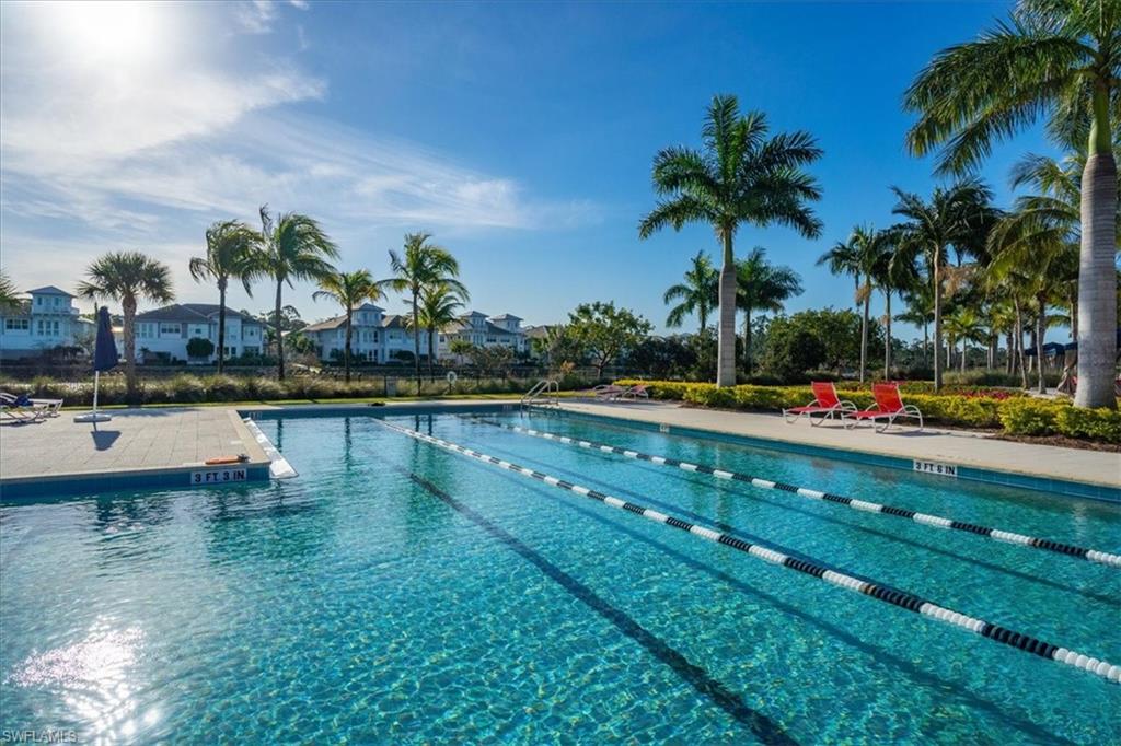 6509 Dominica Drive, Unit 101 Naples, FL 34113 - Photo 29 of 33 a view of a swimming pool with a table and chairs