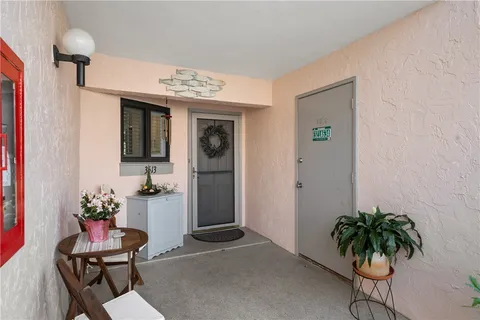 a view of a workspace room with furniture and potted plant
